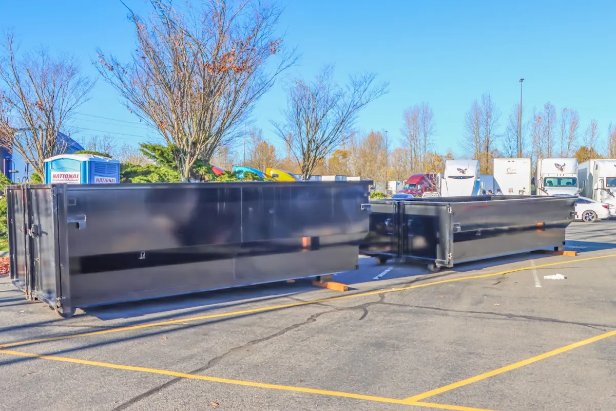 Professional dumpster rental service with roll-off container on residential driveway in Elma